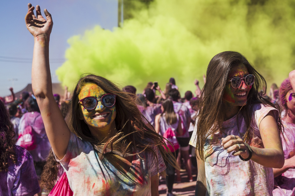 Jeunes filles s'amusant et dansant lors d'un festival avec de la poudre holi